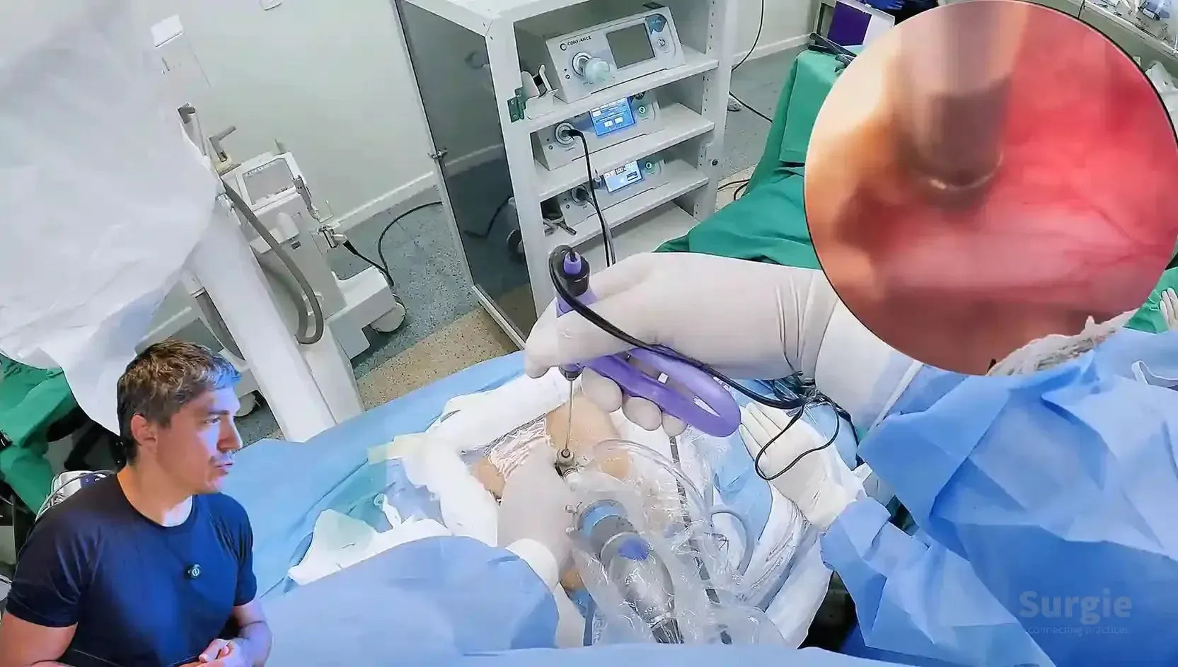 Surgeon performing endoscopic lumbar spine surgery with an inset view of the interlaminar window and surgical instruments.